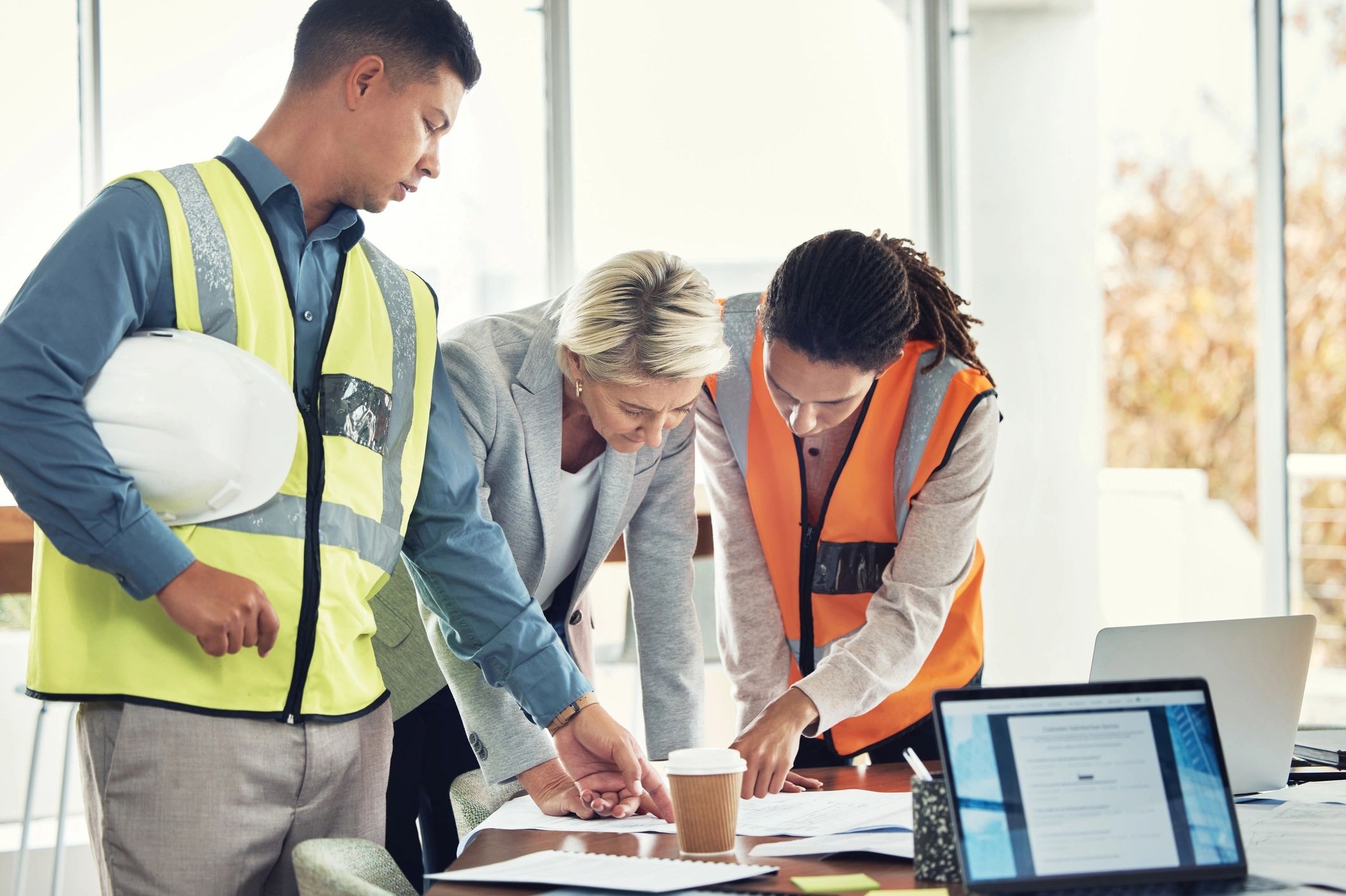Construction professionals reviewing project plans together